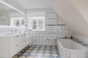 a white bathroom with a tub and a sink at Lunhues Lucia in Dunsum +32 photos