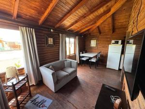 a living room with a couch and a table at Cabañas - Raíces de la Sierra in Balcarce