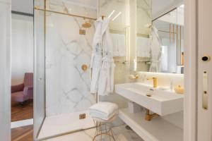 a white bathroom with a sink and a shower at Experience Boutique Hotel - Villa Cimmino in Castellammare di Stabia +72 photos
