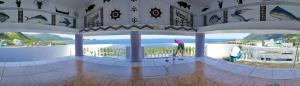 two people standing in a room with a view of the ocean at Yabiya home stay in Lanyu