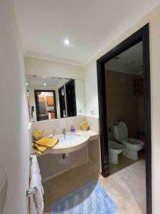 a bathroom with a sink and a toilet at Azul Blue House in Sidi Bouzid +18 photos