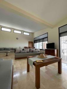 a living room with a couch and a table at Azul Blue House in Sidi Bouzid