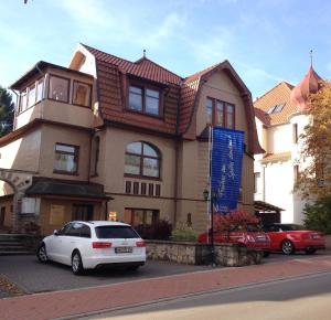 a house with cars parked in front of it at Ferienwohnung Baars in Bad Sachsa