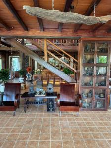 a living room with a table and chairs and wooden ceilings at Moc Homestay & Villa in Cư Chinh