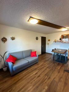 a living room with a couch and a table at Montecampione Prati B in Pian Camuno