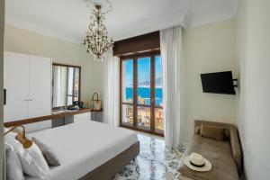a bedroom with a bed and a view of the ocean at Experience Boutique Hotel - Villa Cimmino in Castellammare di Stabia