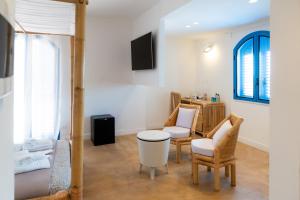 a living room with two chairs and a table at Didimos Resort in Reggio di Calabria