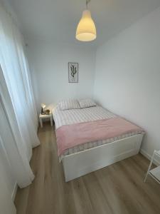 a bedroom with a bed in a white room at The Lemon Tree Villa in Charneca