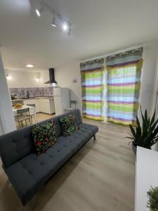 a living room with a couch and a kitchen at The Lemon Tree Villa in Charneca