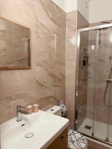 a bathroom with a sink and a shower at Hotel Bonaparte in Bastia +29 photos