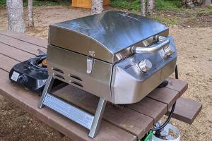 a grill sitting on top of a wooden table at Cozy Cabin #2 in Maynooth