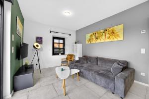 a living room with a couch and a table at JUNIPRO Apartments Bostalsee in Bosen-Eckelhausen