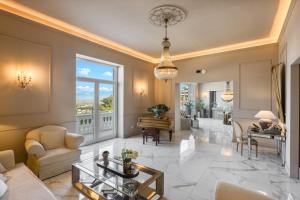 a living room with a table and a piano at Experience Boutique Hotel - Villa Cimmino in Castellammare di Stabia