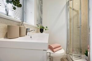 a bathroom with a sink and a toilet at Edegely House in Stockport +19 photos