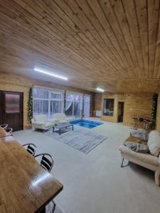 a large living room with a wooden ceiling at Casutele Anei- Aframe&Spa in Rişca +26 photos