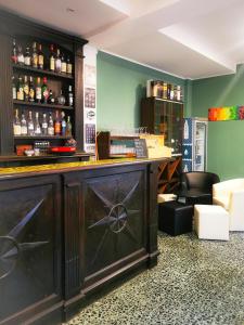 a bar in a room with green walls at Locanda Ponte Rosa in Garessio