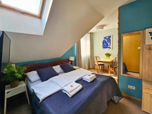 a bedroom with a bed with towels on it at Balia Spa & Wellness in Kazimierz Dolny +96 photos