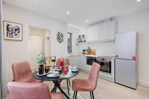 a kitchen with a table and chairs in a room at Edegely House in Stockport