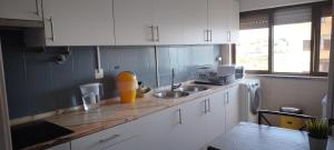 a kitchen with a sink and a counter top at Vieira's House in Barreiro