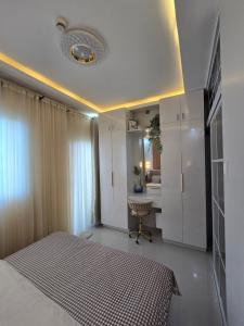 a bedroom with a bed and a desk at Kai's Luxe Balcony Suite at Royal Oceancrest Mactan in Mactan Island +35 photos