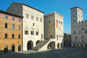 a large building with two towers and a staircase at Casa Erica Todi in Todi