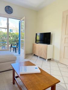 a living room with a tv and a coffee table at Villa Galazia in Megalochori