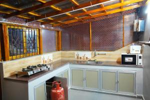 a kitchen with a sink and a stove in it at Green Heavan Farm in Sadras