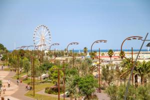a park with a ferris wheel in the background at Residence Mimosa in Rimini