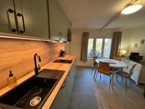 a kitchen with a sink and a table at Chalupa u Lacinů in Mirošovice +24 photos