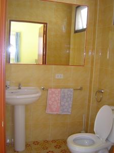 a bathroom with a sink and a toilet and a mirror at Mini-golf **** & Resort Ubon Ratchathani in Ubon Ratchathani +94 photos