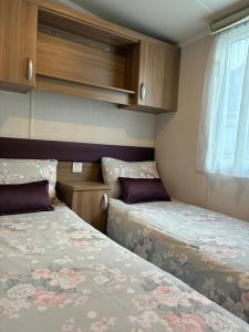 a small room with two beds and a window at Bordeaux sea view no 9 in Ardentinny