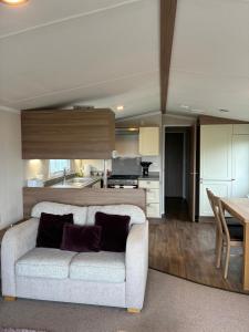 a living room with a couch and a kitchen at Bordeaux sea view no 9 in Ardentinny