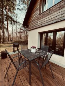 a patio with a table and chairs on a deck at Chalupa u Lacinů in Mirošovice