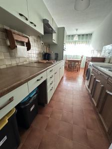 a kitchen with white cabinets and a tile floor at Casa LynaeL Saint Roch in Nice +17 photos