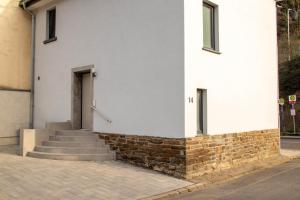 a white building with stairs and a door at Apartments-Altenahr in Altenahr