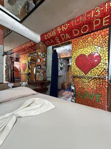 a bedroom with a bed with a sign that says love at Rocking J's in Puerto Viejo +203 photos