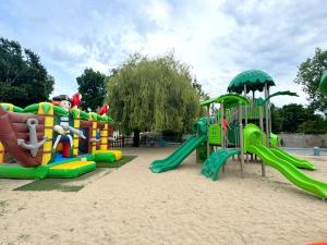 a playground with a slide in the sand at Tente avec terrasse - 2 pers. - API-1-52-2040 in Grayan-et-lʼHôpital