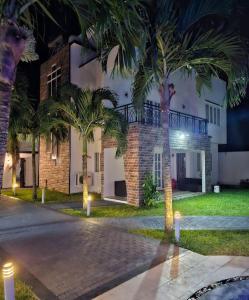 a house with palm trees in front of it at night at Sea Bliss Villa1 in Pereybere