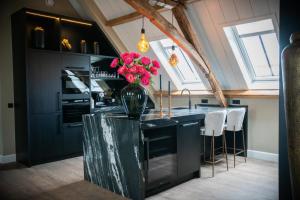 a kitchen with a vase of flowers on a counter at Room4 in Maurik