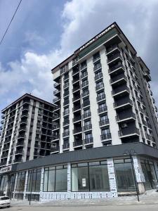 a large apartment building with a lot of windows at Dialb Apartments in Debar