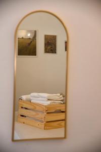a mirror reflection of a bed in a room at Tracce nel Borgo in Putignano