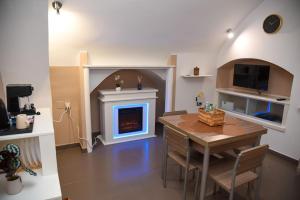 a living room with a table and a fireplace at Tracce nel Borgo in Putignano
