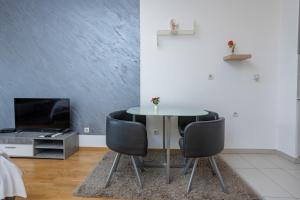 a dining room with a table and two chairs at Don Vito in Belgrade