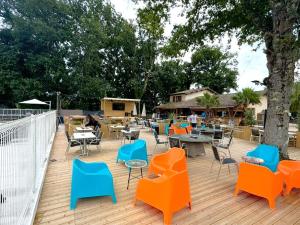 an outdoor patio with chairs and tables and chairs at Tente avec terrasse - 2 pers. - API-1-52-2040 in Grayan-et-lʼHôpital