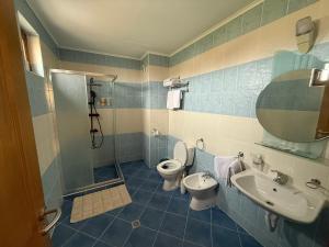 a bathroom with a shower and a toilet and a sink at Златна люспа in Bŭlgarevo +11 photos