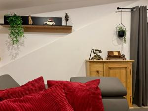 a living room with a couch with red pillows at LuxLife - Panorama Bergblick, Sauna, Balkon, Luxus Pur in Buchenberg