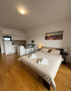 a bedroom with a large bed with two towels on it at Pipanova Cosy Nest with Balcony & Free Parking in Ljubljana