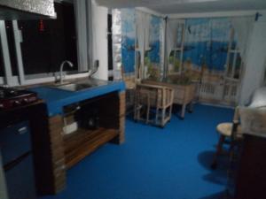 a kitchen with a sink and a blue floor at The Blue Apartment in Puerto Ángel