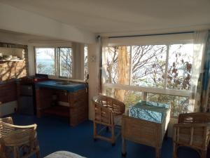 a kitchen with a table and chairs and a window at The Blue Apartment in Puerto Ángel