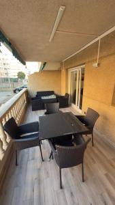 a balcony with tables and chairs on a building at Turquesa 10 in La Pineda